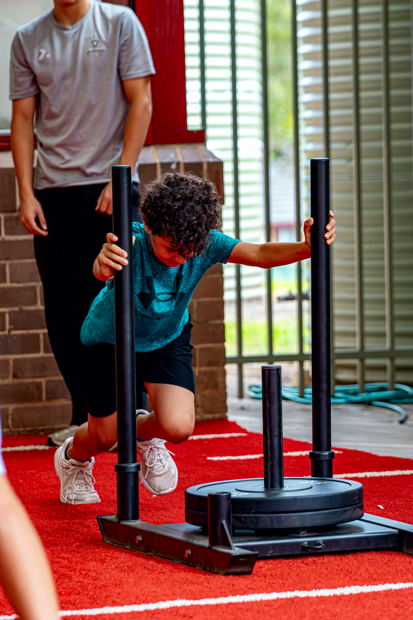 An athlete driving a weighted sled.