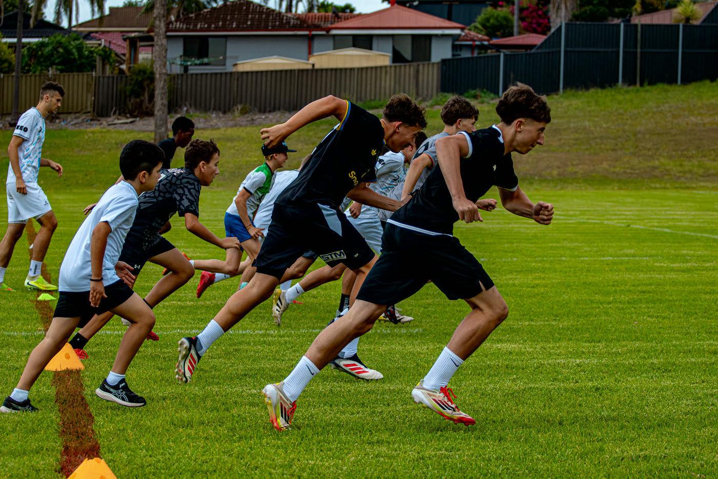 Players exploding off the mark during a sprint-start drill.