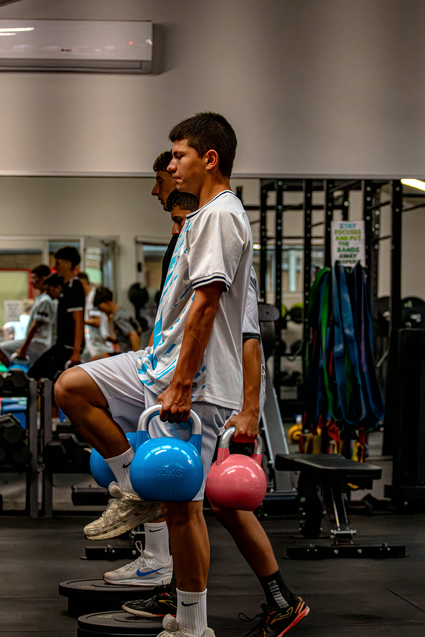 Gamechanger athletes working through a loaded carry in the private gym at Gamechanger HQ.